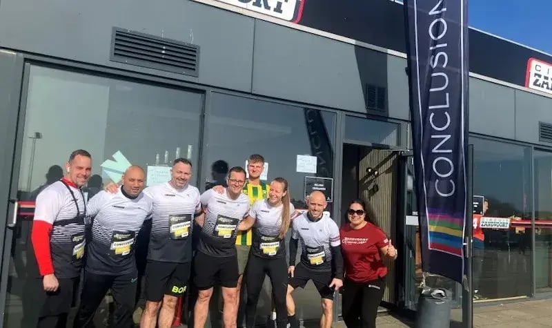 Colleagues in Conclusion attire at the Zandvoort Circuit before the run.