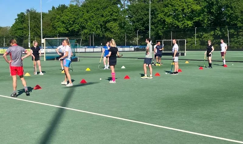 Colleagues training on a hockey field.