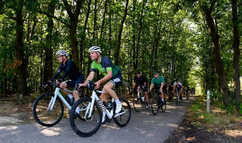 Colleagues on bicycles participating in the Tour de Conclusion.