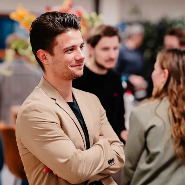 Man laughing with arms crossed.