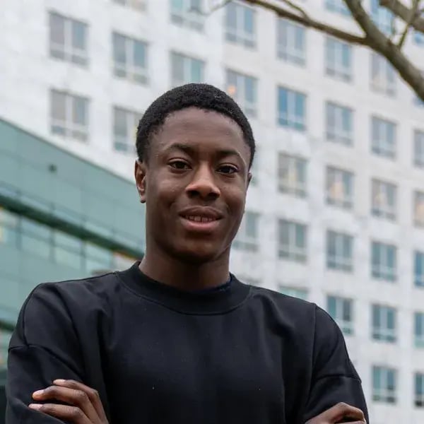 Laolu smiling in front of a building